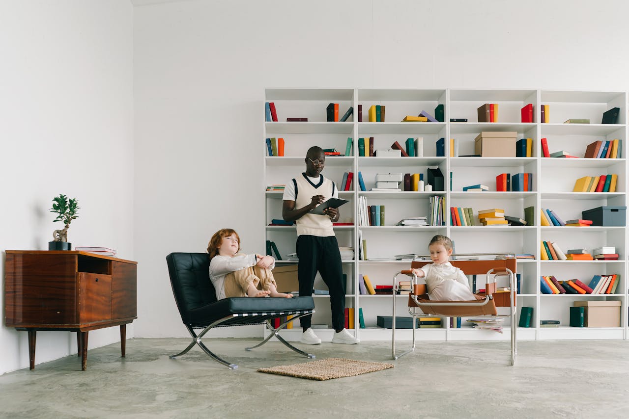 Psychologist conducts a therapy session with children in a modern library setting.
